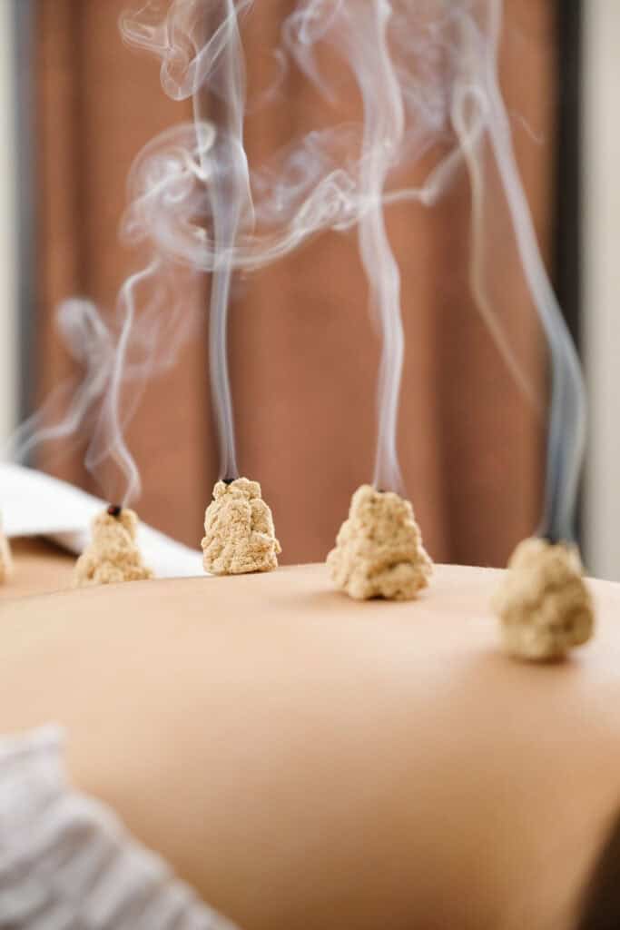 Aromatherapy massage with incense and steam for relaxation and wellness.