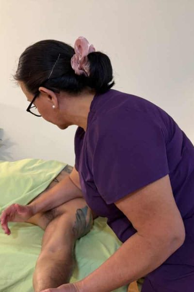 Massage therapist providing therapy in a relaxing spa setting.